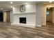 Charming living room with a white brick fireplace, hardwood floors, and stylish accents at 6787 Hembree Dr, Austell, GA 30168