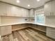 Bright office space featuring custom built-in desk, modern cabinets and wood-look flooring at 6787 Hembree Dr, Austell, GA 30168