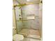 Elegant tiled shower with gold accents and glass enclosure at 6787 Hembree Dr, Austell, GA 30168