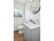 Modern bathroom featuring a new sink, toilet, and vanity with a round mirror at 1189 Kathryn Cir, Forest Park, GA 30297