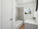 Well-lit bathroom featuring new tile and a modern vanity with a round mirror at 1189 Kathryn Cir, Forest Park, GA 30297