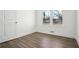 Bedroom featuring hardwood floors, fresh white paint, and a large window with nature views at 1189 Kathryn Cir, Forest Park, GA 30297