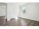 Well-lit bedroom featuring hardwood floors, fresh white paint, and a large window with nature views at 1189 Kathryn Cir, Forest Park, GA 30297