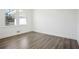 Bedroom featuring hardwood floors, fresh white paint, and a large window with neighborhood views at 1189 Kathryn Cir, Forest Park, GA 30297