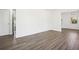Spacious living room with updated wood flooring, white walls, and natural light at 1189 Kathryn Cir, Forest Park, GA 30297
