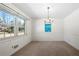 Bright dining room with a charming chandelier, neutral carpet, and a large window that offers ample natural light at 1331 Woodhill Dr, Marietta, GA 30066