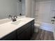 Bathroom with a dark vanity, white counter tops, wood flooring, and a shower at 4371 Portsbrook Ave, Snellville, GA 30039
