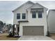 Charming new construction featuring a brick and clapboard facade, and a two-car garage at 4371 Portsbrook Ave, Snellville, GA 30039
