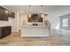 Bright kitchen with stainless steel appliances, granite countertops, and an island with bar seating and pendant lights at 4371 Portsbrook Ave, Snellville, GA 30039