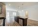 Kitchen island showcases a granite countertop, stainless sink and appliances, seamlessly blending into the living space at 4371 Portsbrook Ave, Snellville, GA 30039