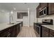 Contemporary kitchen featuring stainless steel appliances, and dark cabinets at 4371 Portsbrook Ave, Snellville, GA 30039