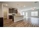 Bright open-concept kitchen featuring dark cabinets, an island, and stainless steel appliances at 4371 Portsbrook Ave, Snellville, GA 30039