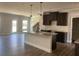 Modern kitchen with an island, dark cabinets, stainless steel appliances, and subway tile backsplash at 4371 Portsbrook Ave, Snellville, GA 30039