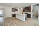 Modern kitchen boasts stainless appliances, dark wood cabinetry, and a stylish island with pendant lighting at 4371 Portsbrook Ave, Snellville, GA 30039
