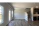 Open living space with lots of windows and luxury vinyl plank flooring and access to the kitchen and the second floor at 4371 Portsbrook Ave, Snellville, GA 30039