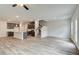 Open-concept living area features a kitchen with dark cabinets, stairs to the second level, and luxury vinyl plank flooring at 4371 Portsbrook Ave, Snellville, GA 30039