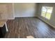 Bright living area featuring luxury vinyl plank flooring, complemented by a large window, near the kitchen at 4371 Portsbrook Ave, Snellville, GA 30039
