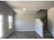 Spacious living area boasts natural light, and staircase access to upper floors, complemented by modern vinyl floors at 4371 Portsbrook Ave, Snellville, GA 30039