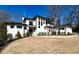 Attractive white home with a contemporary design, neat landscaping, and a walkway leading to the entryway at 4524 Mystic Dr, Sandy Springs, GA 30327