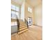 Inviting home foyer with natural wood stairs, black railing and contemporary style at 4524 Mystic Dr, Sandy Springs, GA 30327
