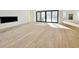 Expansive living area featuring gleaming hardwood floors, large windows, and a modern fireplace at 4524 Mystic Dr, Sandy Springs, GA 30327