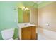 Green bathroom featuring a single sink vanity, toilet, and tiled shower-tub combo at 1555 Mosaic Way # 1555, Smyrna, GA 30080