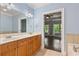 Bathroom showcasing a double sink vanity with wood cabinets and a view to the bedroom at 1555 Mosaic Way # 1555, Smyrna, GA 30080