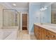Bright bathroom featuring a double sink vanity, soaking tub, and separate glass shower at 1555 Mosaic Way # 1555, Smyrna, GA 30080