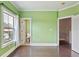 Green bedroom with hardwood floors and two entryways at 1555 Mosaic Way # 1555, Smyrna, GA 30080