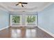 Primary bedroom with crown molding, recessed lighting, hardwood floors, and views of the trees outside at 1555 Mosaic Way # 1555, Smyrna, GA 30080