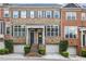 Charming brick townhome with well-manicured landscaping, covered entryway, and attached garages at 1555 Mosaic Way # 1555, Smyrna, GA 30080