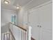 Upstairs hallway with white railing, hardwood floors, and access to multiple rooms at 1555 Mosaic Way # 1555, Smyrna, GA 30080