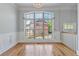 Sun-drenched living room showcasing large windows, hardwood floors, and elegant wainscoting at 1555 Mosaic Way # 1555, Smyrna, GA 30080