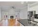 Living room and kitchen with stainless steel appliances, fireplace, ceiling fan, and access to the outdoor deck at 1555 Mosaic Way # 1555, Smyrna, GA 30080