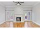 Bright living room featuring a fireplace, hardwood floors, ceiling fan, and doors to the outdoor space at 1555 Mosaic Way # 1555, Smyrna, GA 30080