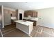 Bright kitchen featuring light wood cabinets, a marble countertop island, and stainless steel appliances at 156 Easton Park Blvd, Dallas, GA 30157