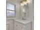 Bright bathroom featuring a marble vanity with chrome fixtures and a decorative light fixture at 265 Haas Se Ave, Atlanta, GA 30316