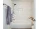 Bright bathroom features a white bathtub, shower with marble-look tiled walls, and modern fixtures at 265 Haas Se Ave, Atlanta, GA 30316