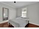 Comfortable bedroom features hardwood floors, soft grey walls, queen-sized bed, and window with blinds at 265 Haas Se Ave, Atlanta, GA 30316