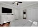 Cozy bedroom boasts hardwood floors, neutral paint, tv, and plentiful storage with double closets at 265 Haas Se Ave, Atlanta, GA 30316