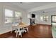 Open dining area with hardwood floors adjacent to living room with brick fireplace at 265 Haas Se Ave, Atlanta, GA 30316