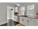 Bright kitchen view featuring white cabinets, granite countertops, stainless steel appliances, and dark tiled floors at 265 Haas Se Ave, Atlanta, GA 30316