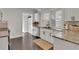 View of the kitchen area featuring white cabinets, a granite counter, stainless steel appliances, and tiled floors at 265 Haas Se Ave, Atlanta, GA 30316