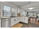 Well-lit kitchen featuring granite countertops, white cabinets, stainless steel appliances, and a view of living area at 265 Haas Se Ave, Atlanta, GA 30316