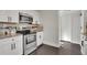 Updated kitchen with stainless steel appliances, white cabinets, granite countertops, and stylish tiled floor at 265 Haas Se Ave, Atlanta, GA 30316