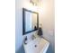 Chic bathroom with a pedestal sink, elegant mirror, and modern fixtures at 419 Hargrove Ln, Decatur, GA 30030