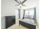 Cozy bedroom featuring a ceiling fan, windows with blinds, and a matching dark dresser and bed frame at 419 Hargrove Ln, Decatur, GA 30030