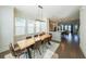 Dining room features a long wooden table, modern chandelier, and large windows at 419 Hargrove Ln, Decatur, GA 30030