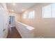 Hallway with hardwood floors, white walls and trim, multiple windows, and access to other rooms at 419 Hargrove Ln, Decatur, GA 30030