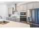 Modern kitchen with stainless steel appliances, white cabinets, and subway tile backsplash at 419 Hargrove Ln, Decatur, GA 30030